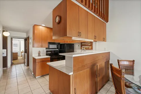 a kitchen with cabinets and steel appliances
