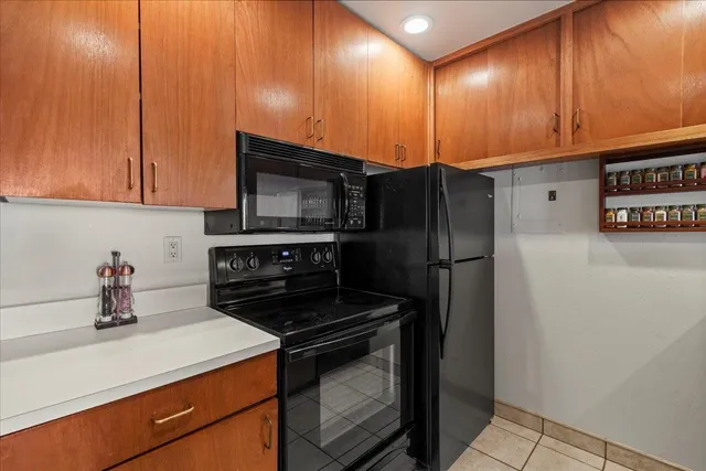 a kitchen with a sink a refrigerator and cabinets