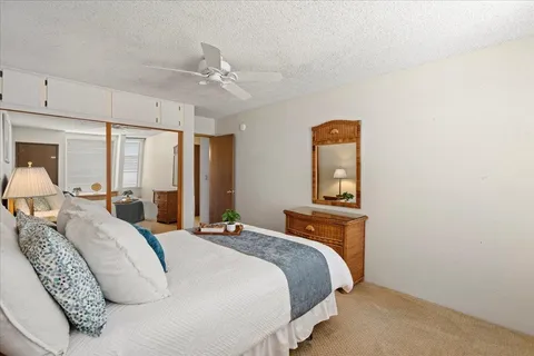 a bedroom with bed and a chandelier