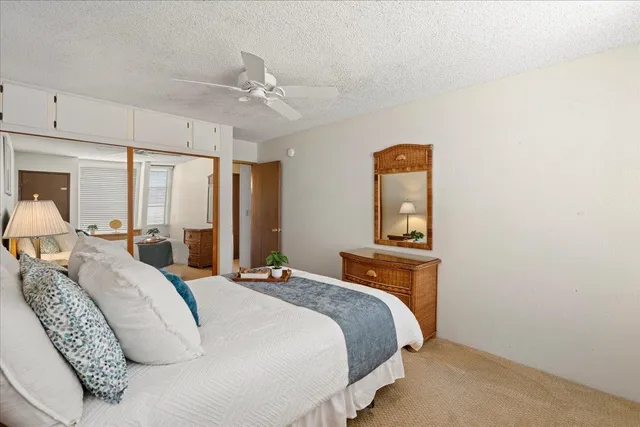 a bedroom with a bed and a dresser