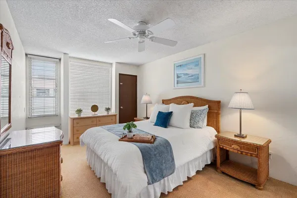 a bedroom with bed and a chandelier