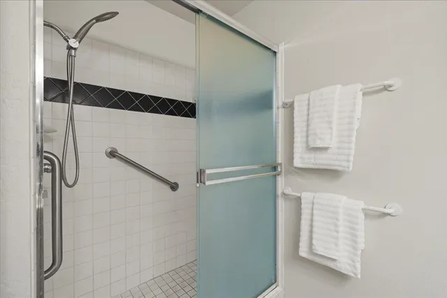 a bathroom with a shower and a mirror