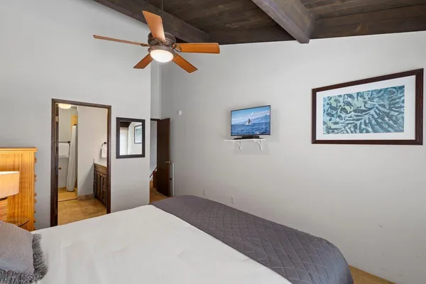 a bedroom with a bed and a chandelier