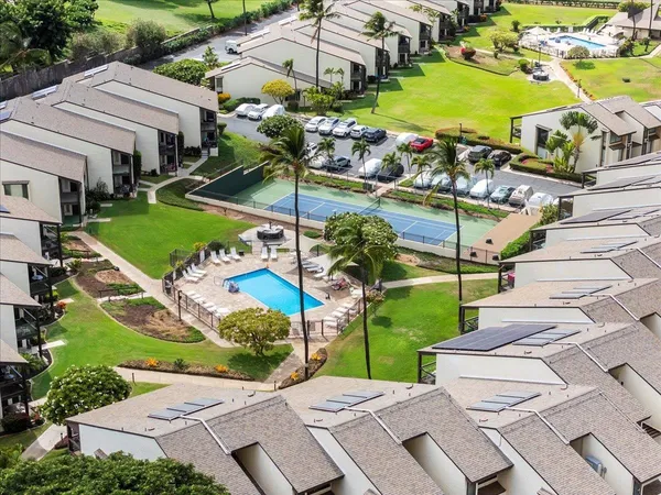 an aerial view of a house with a garden and swimming pool