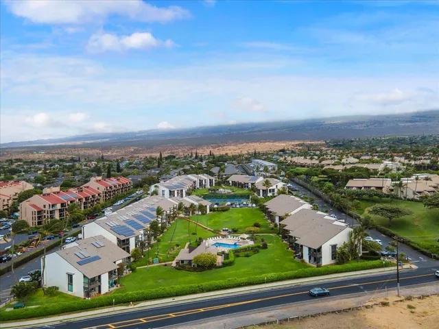 an aerial view of residential building and car parked on street side