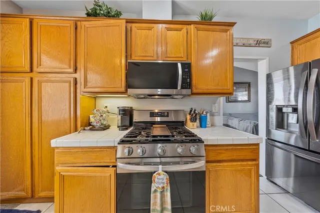 a kitchen with sink a stove and chairs