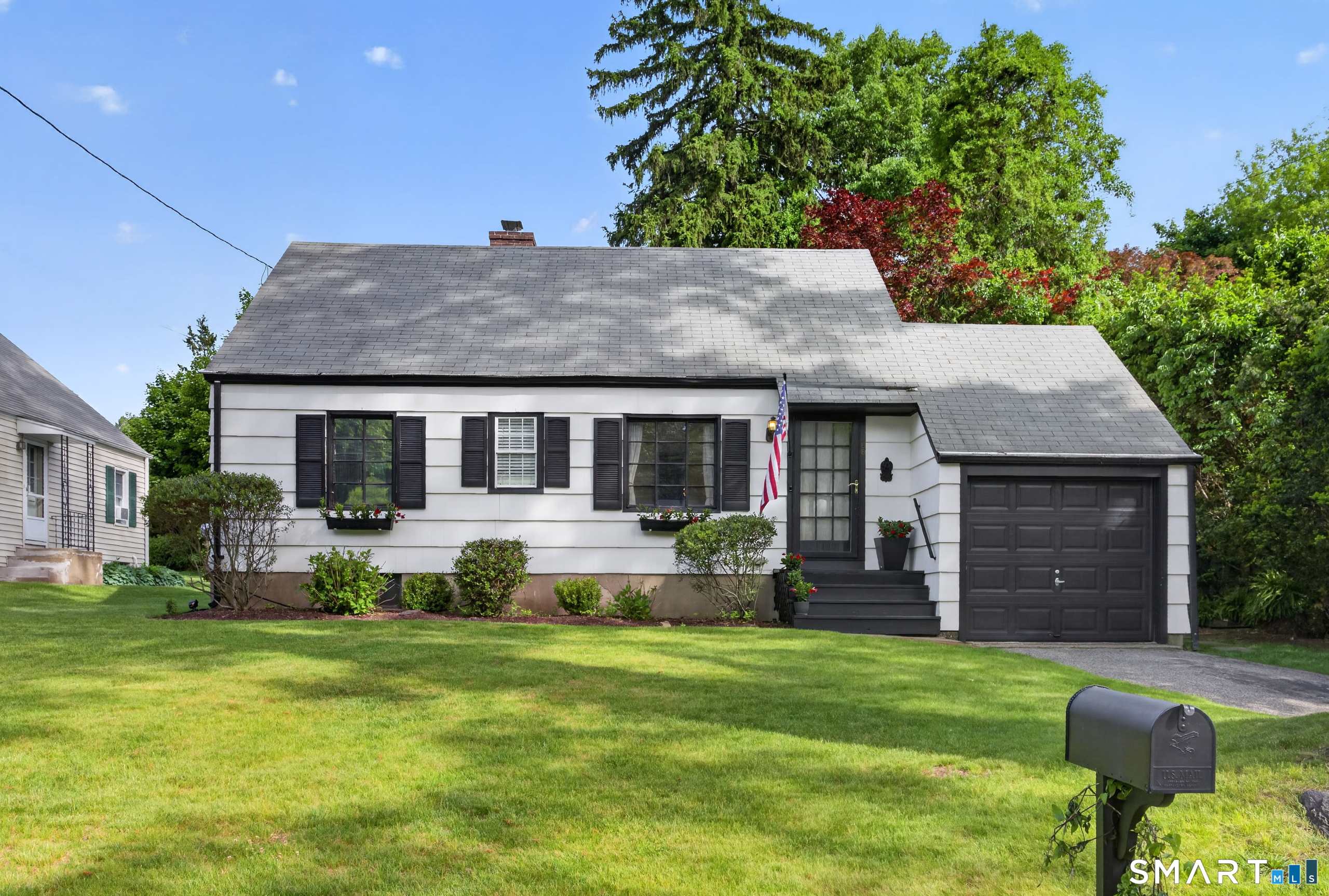68 Old Elm Road Fairfield, CT 06825 - Photo 2 of 40 a front view of a house with a garden and porch