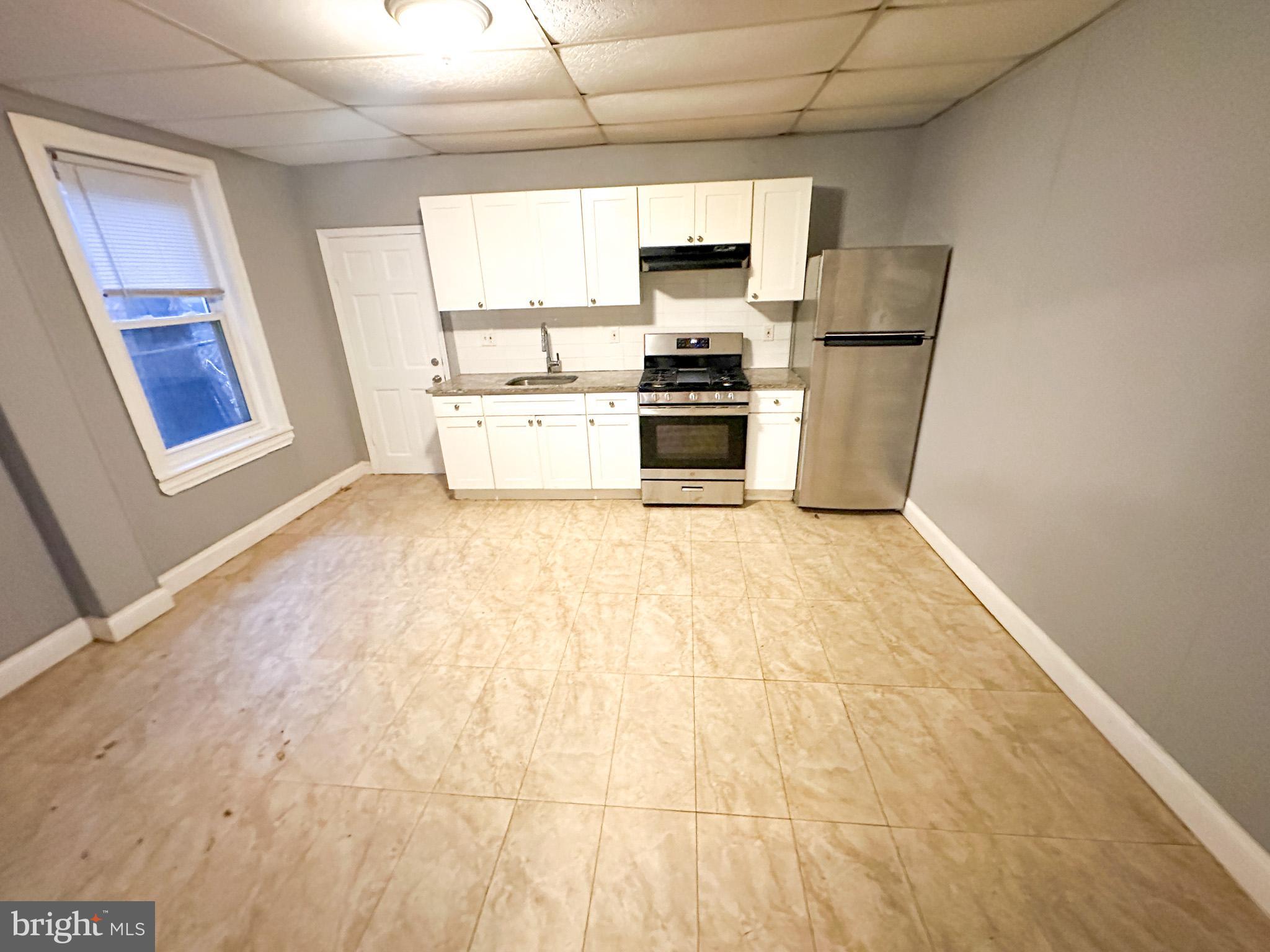 a kitchen with stainless steel appliances a refrigerator stove microwave and sink