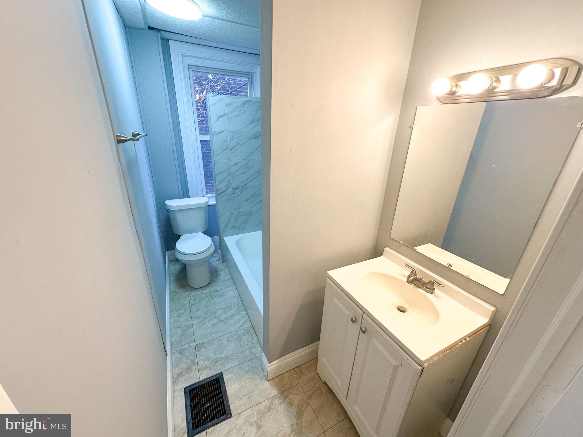 330 North 53rd Street Philadelphia, PA 19139 - Photo 12 of 20 a bathroom with a sink a toilet and mirror