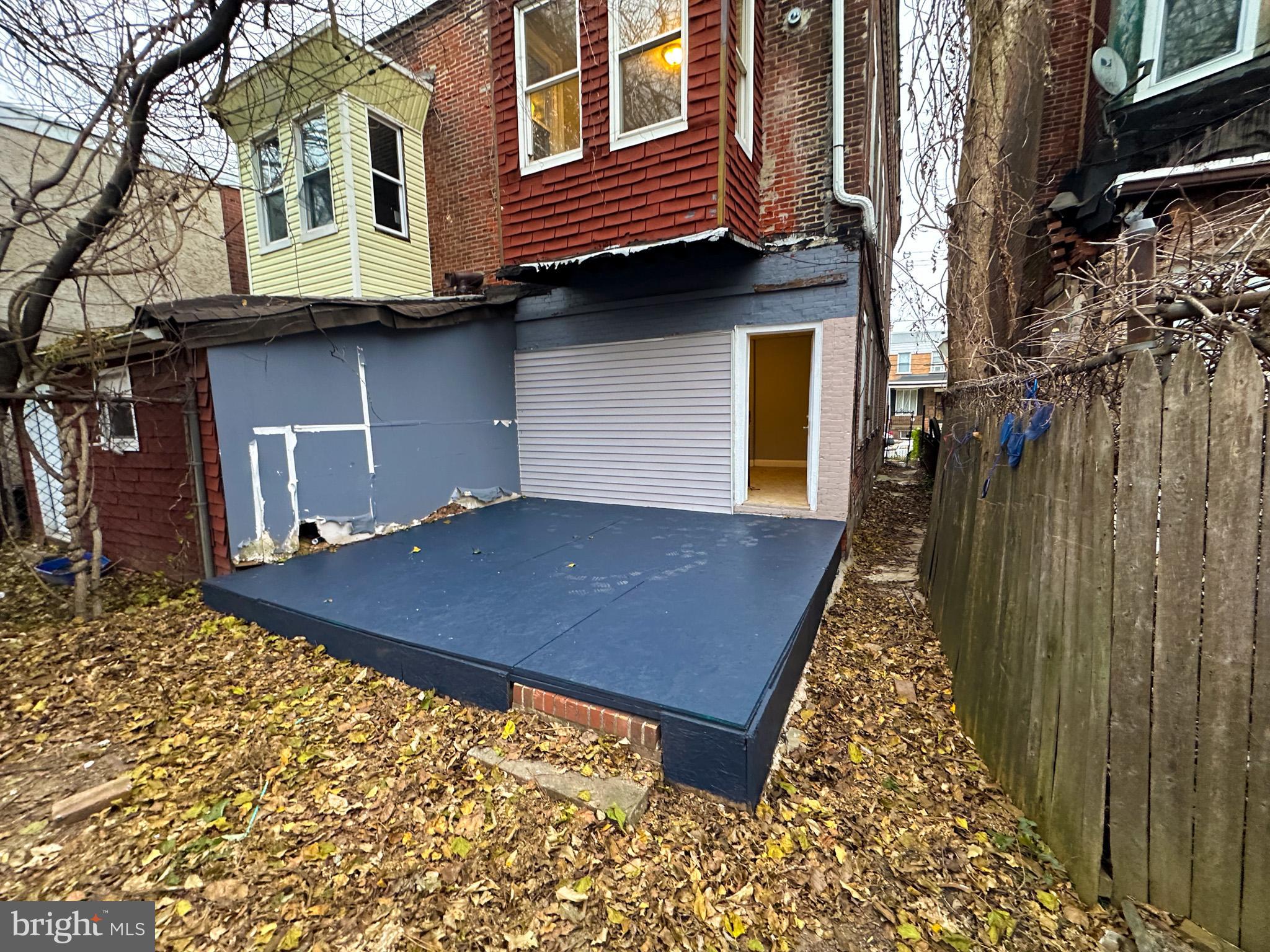 330 North 53rd Street Philadelphia, PA 19139 - Photo 18 of 20 a backyard of a house with wooden fence and a large tree