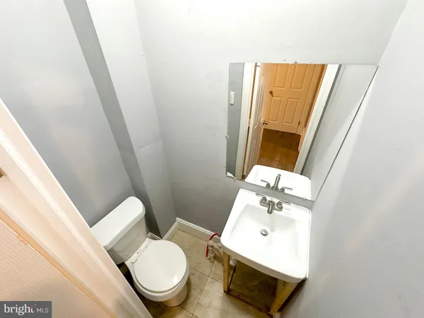 a white toilet sitting next to a bathroom sink