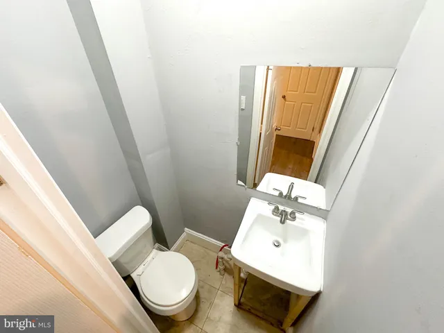 a white toilet sitting next to a bathroom sink