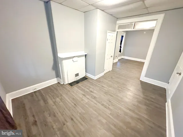 an empty room with wooden floor and closet
