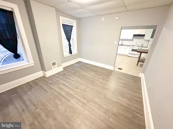 a view of a kitchen with wooden floor and electronic appliances