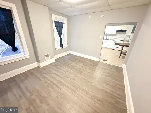 a view of a kitchen with wooden floor and electronic appliances