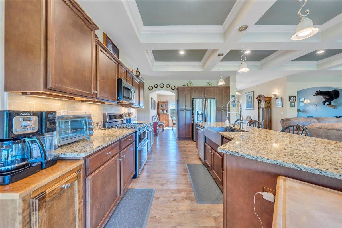398 River Ridge Road Southeast Copper Hill, VA 24079 - Photo 21 of 93 a kitchen with kitchen island granite countertop lots of counter top space and wooden floor