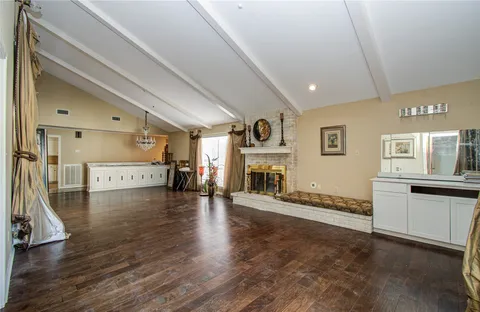 a kitchen with granite countertop white cabinets stainless steel appliances a sink and a window