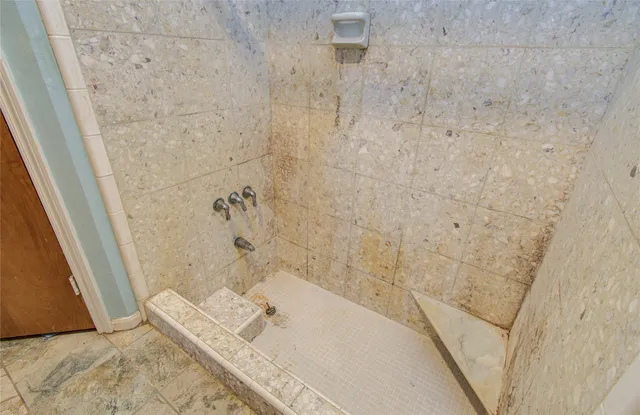 a bathroom with a bathtub and shower