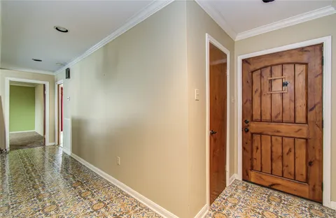 a view of an empty room with window and fireplace