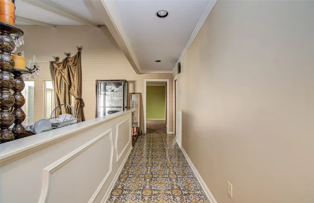 a hallway with a large window and a potted plant