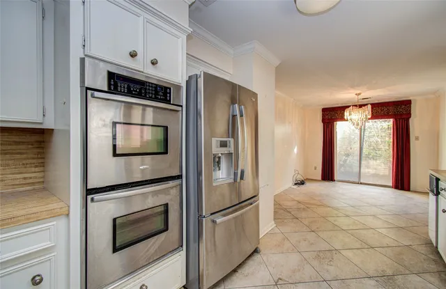 a kitchen with stainless steel appliances a refrigerator and a stove top oven