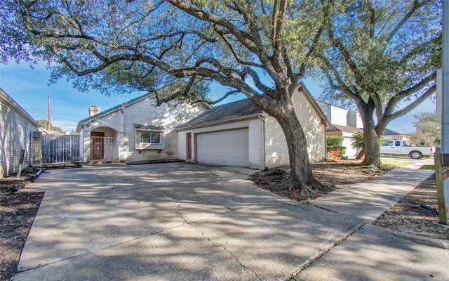 a view of a house with a yard and tree