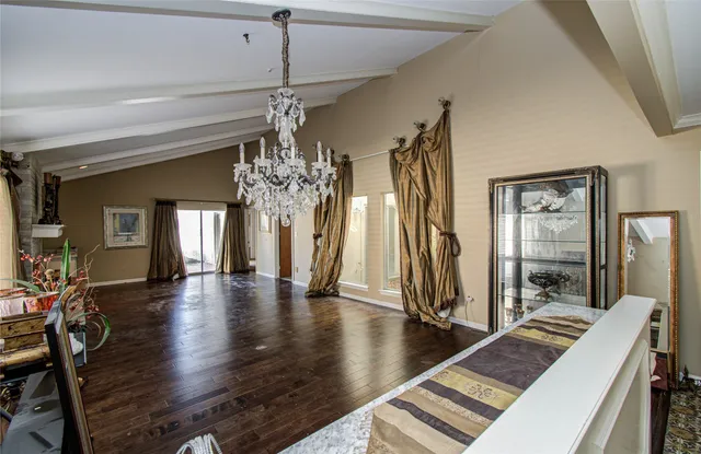 a view of a living room and chandelier with wooden floor