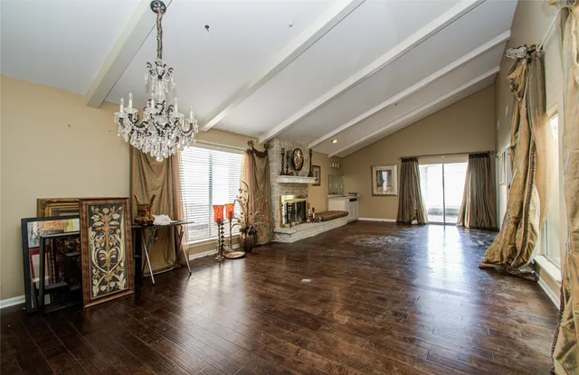 a living room with fireplace furniture and a chandelier
