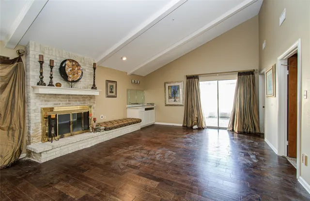 a view of an empty room with window and fireplace