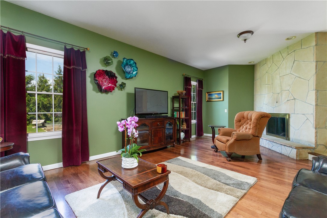 401 Laten Knight Road Cranston, RI 02921 - Photo 21 of 49 Family room with stone faced wall wood burning fireplace