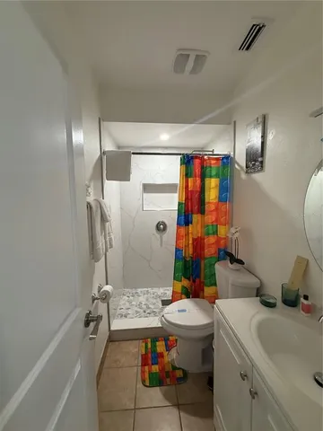 a bathroom with a sink mirror vanity and toilet