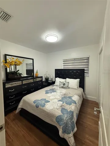 a bedroom with a bed and a television