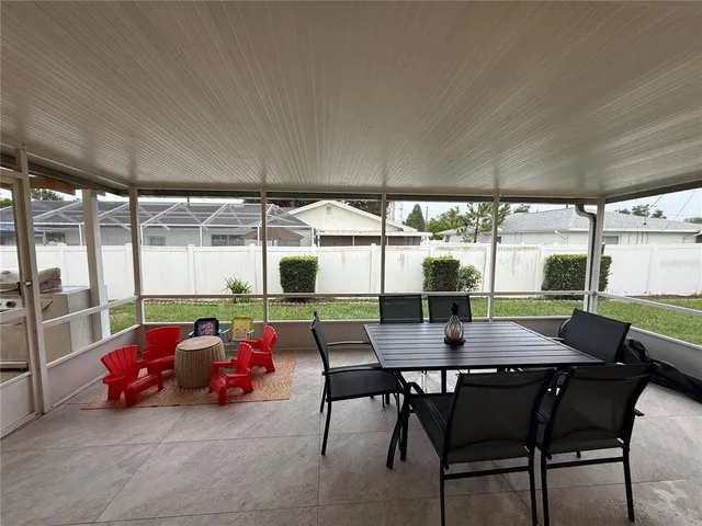 a view of a dining room with furniture and window