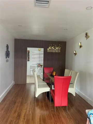 a view of a room with furniture wooden floor and front door