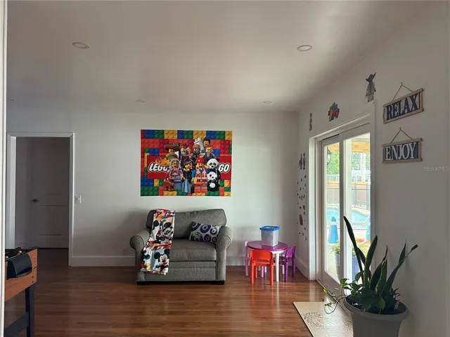 a living room with furniture wooden floor and a potted plant