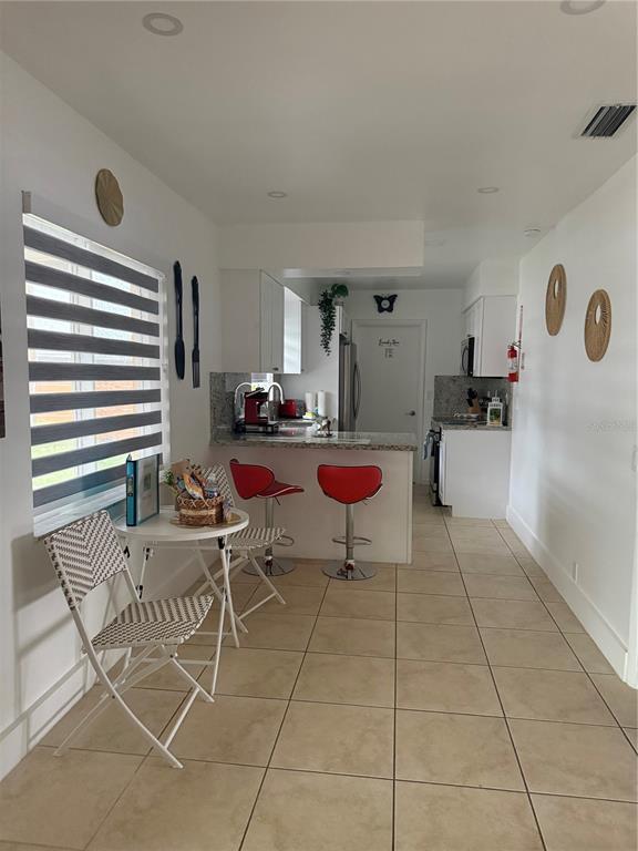 112 Lagoon Road Winter Haven, FL 33884 - Photo 7 of 21 a living room with furniture and a floor to ceiling window