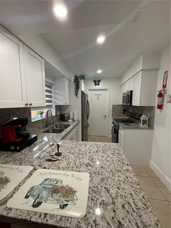 a kitchen with a sink stove and refrigerator