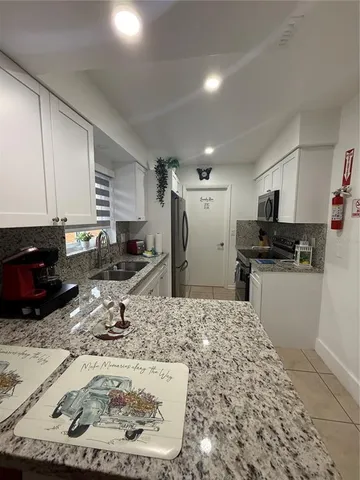 a kitchen with a sink stove and refrigerator