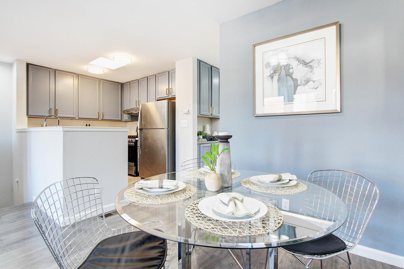 128 Orsi Circle San Francisco, CA 94124 - Photo 14 of 40 a kitchen with stainless steel appliances granite countertop a dining table and chairs