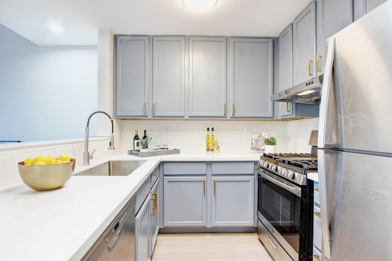 128 Orsi Circle San Francisco, CA 94124 - Photo 15 of 40 a kitchen with stainless steel appliances granite countertop a sink stove and refrigerator