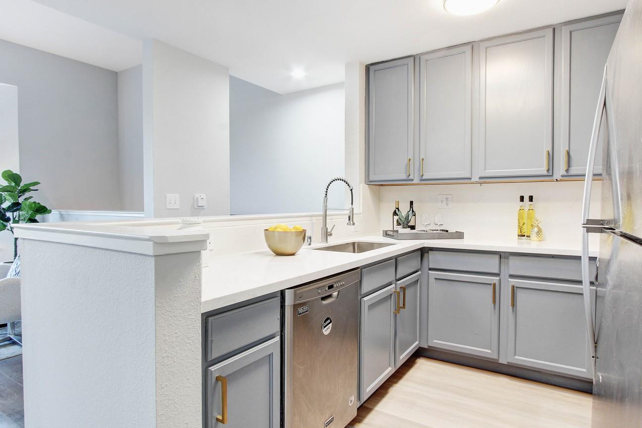 128 Orsi Circle San Francisco, CA 94124 - Photo 16 of 40 a kitchen with a sink cabinets and stainless steel appliances