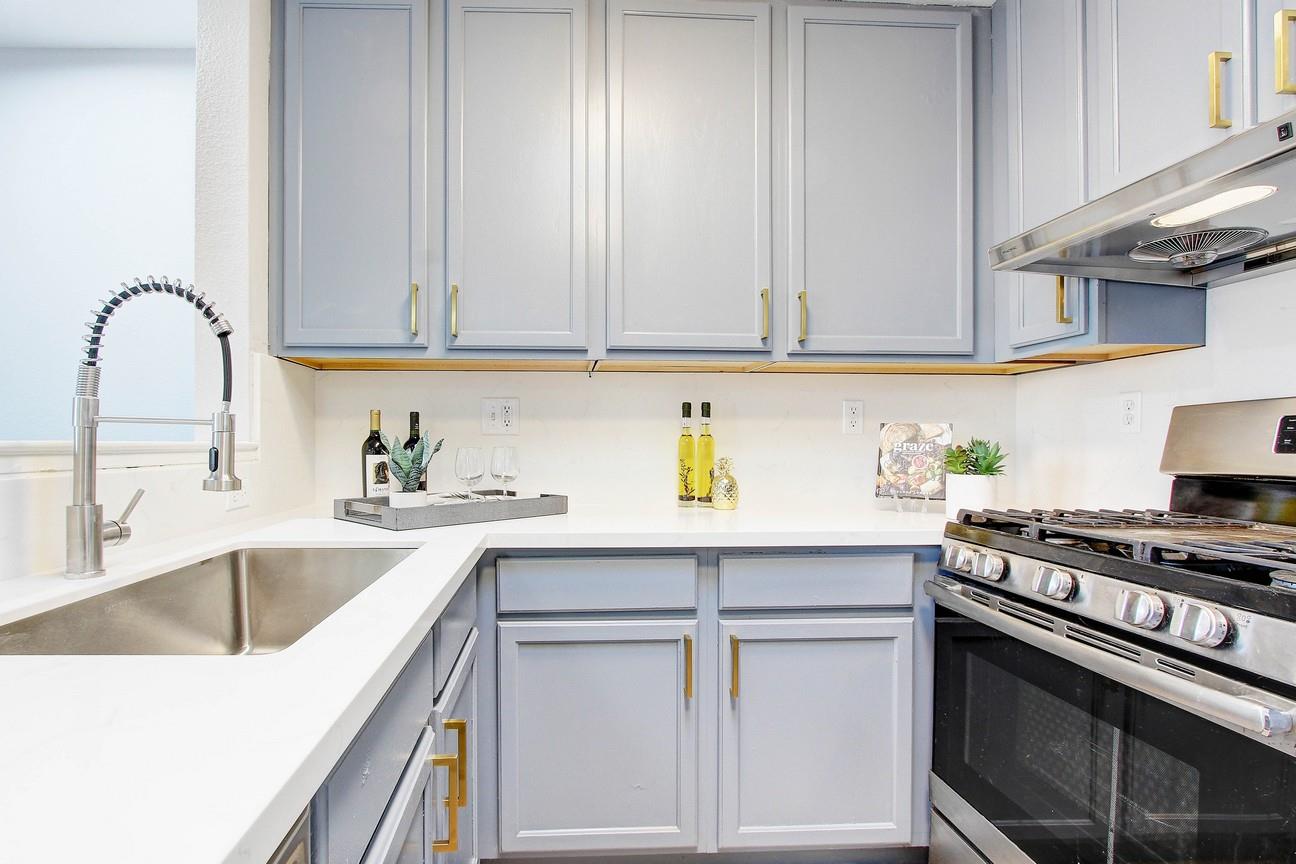 128 Orsi Circle San Francisco, CA 94124 - Photo 17 of 40 a kitchen with granite countertop a sink stainless steel appliances and cabinets