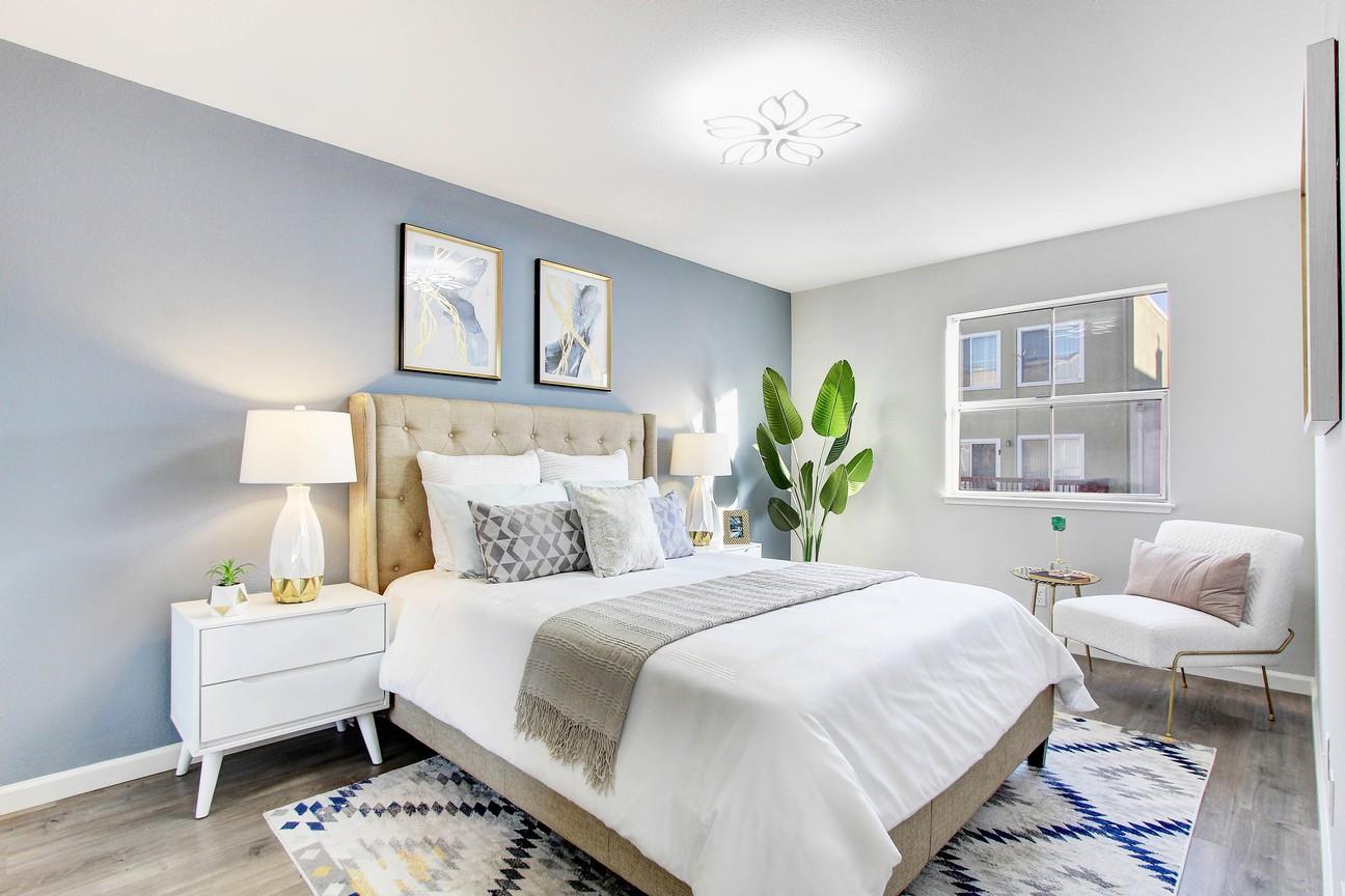 128 Orsi Circle San Francisco, CA 94124 - Photo 21 of 40 a bedroom with a bed and wooden floor