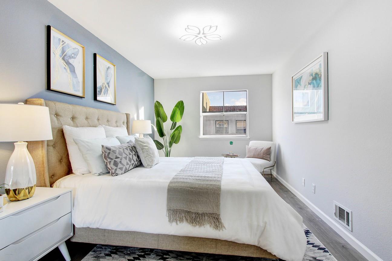 128 Orsi Circle San Francisco, CA 94124 - Photo 23 of 40 a bedroom with a bed and painting on the wall