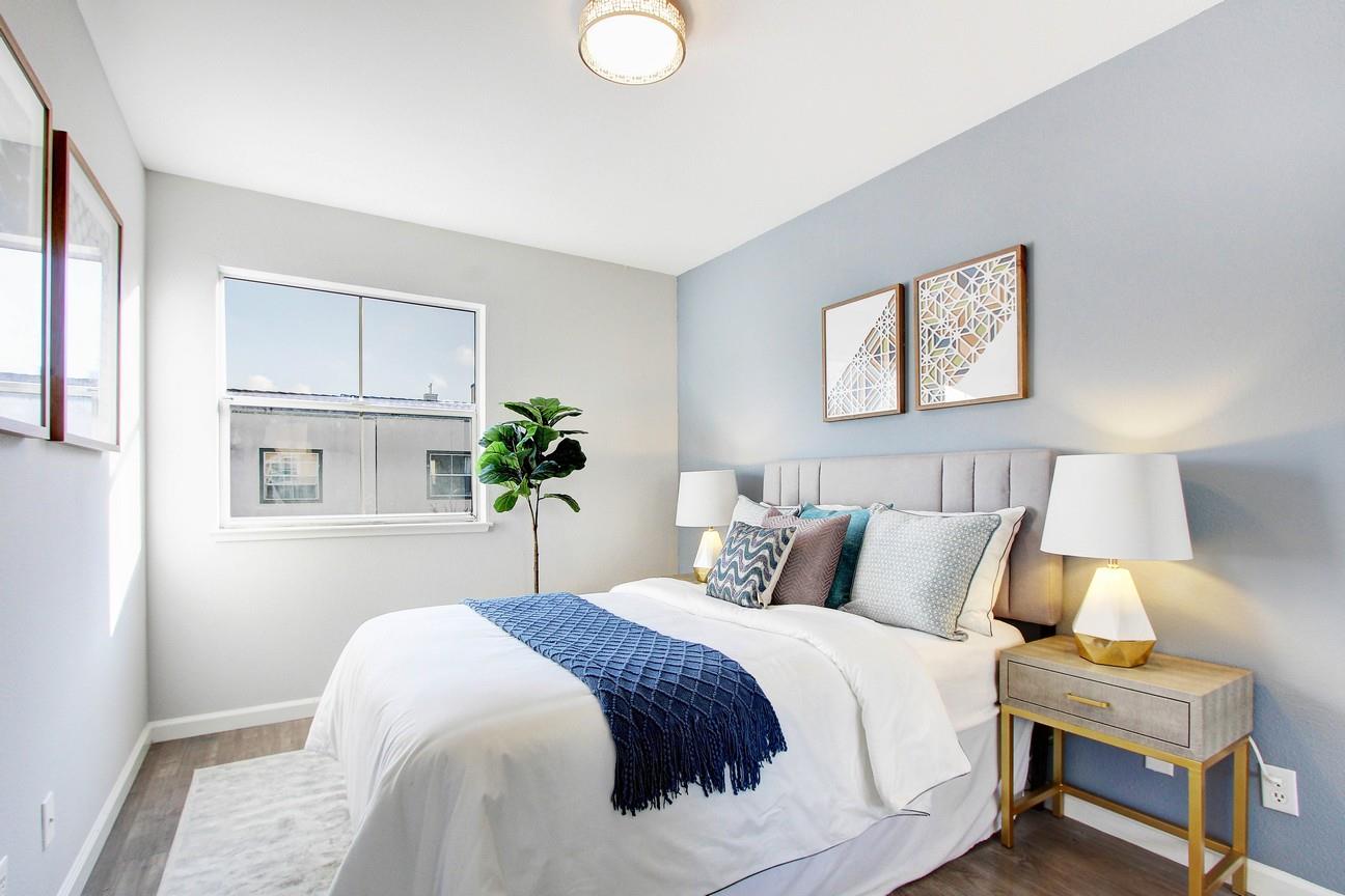 128 Orsi Circle San Francisco, CA 94124 - Photo 24 of 40 a bedroom with a bed and a potted plant