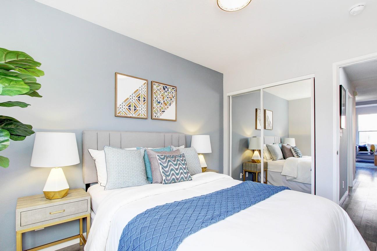 128 Orsi Circle San Francisco, CA 94124 - Photo 25 of 40 a bedroom with a bed and a lamp