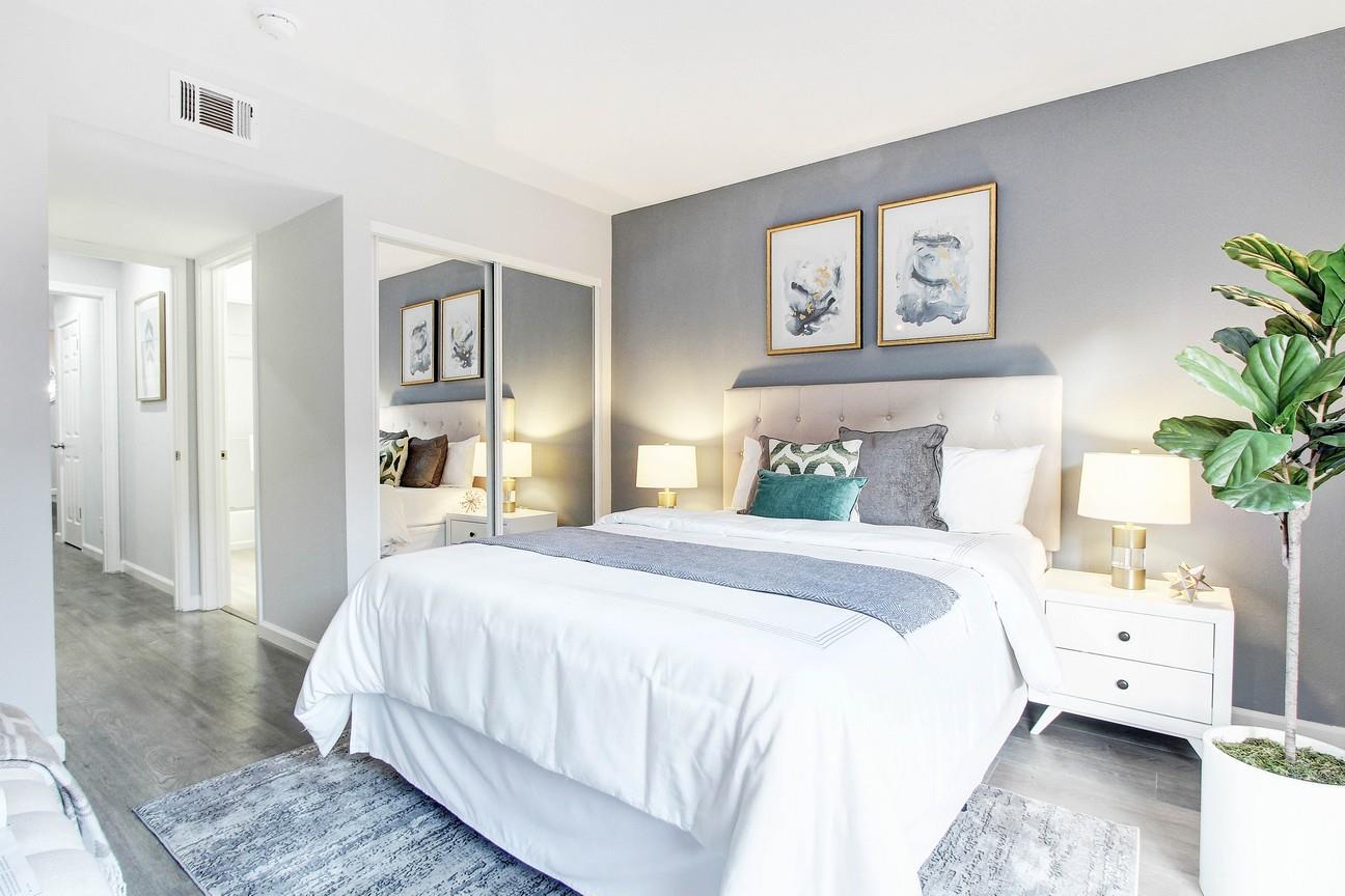 128 Orsi Circle San Francisco, CA 94124 - Photo 29 of 40 a spacious bedroom with a bed and a couch