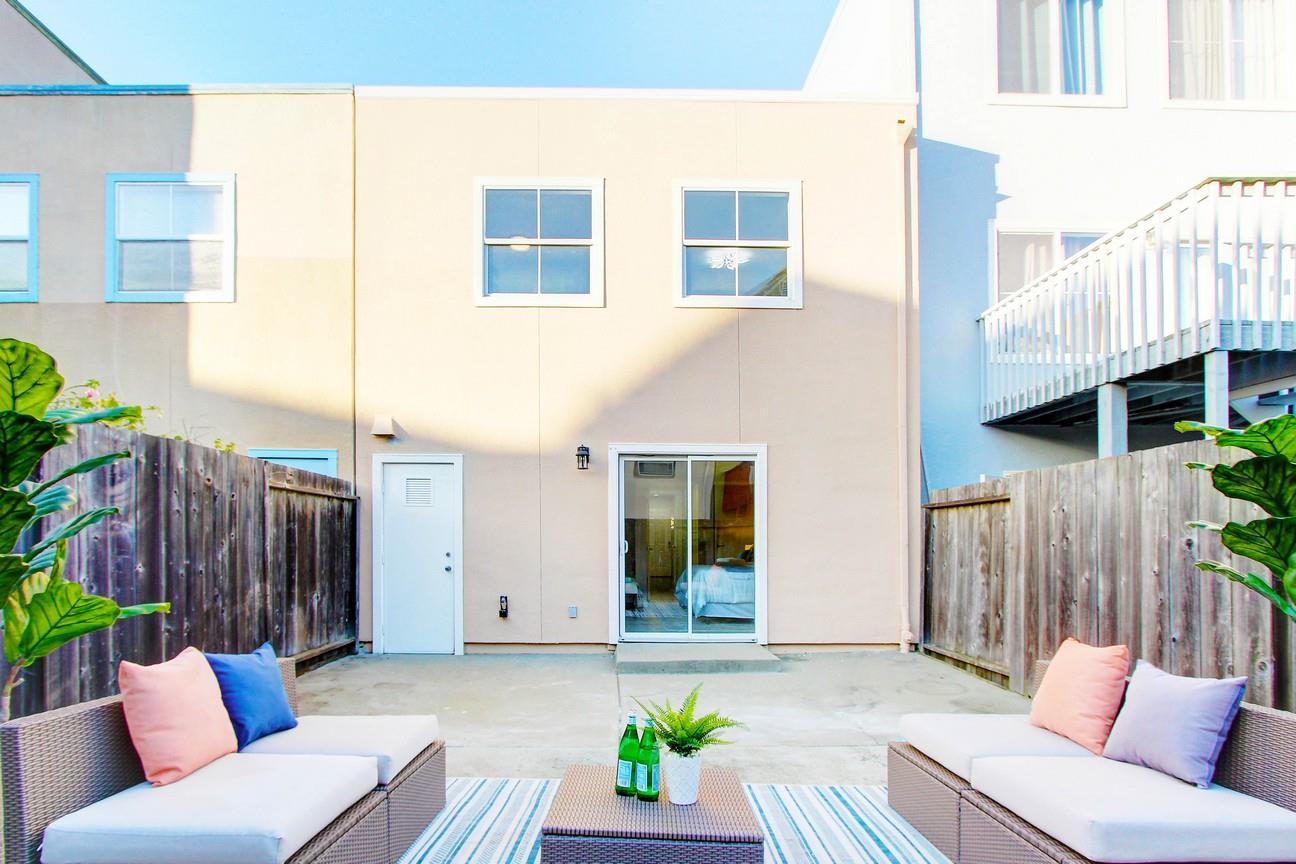 128 Orsi Circle San Francisco, CA 94124 - Photo 33 of 40 a view of a patio with couches table and chairs and wooden fence