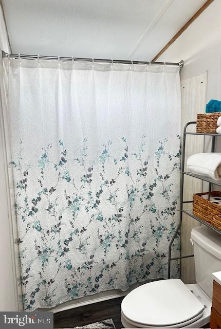 323 Benning Avenue Gettysburg, PA 17325 - Photo 21 of 29 a bathroom with a toilet and a shower curtain