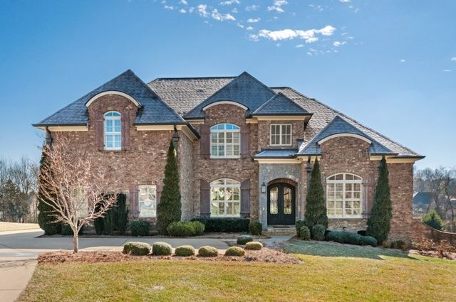 a front view of a house with large yard